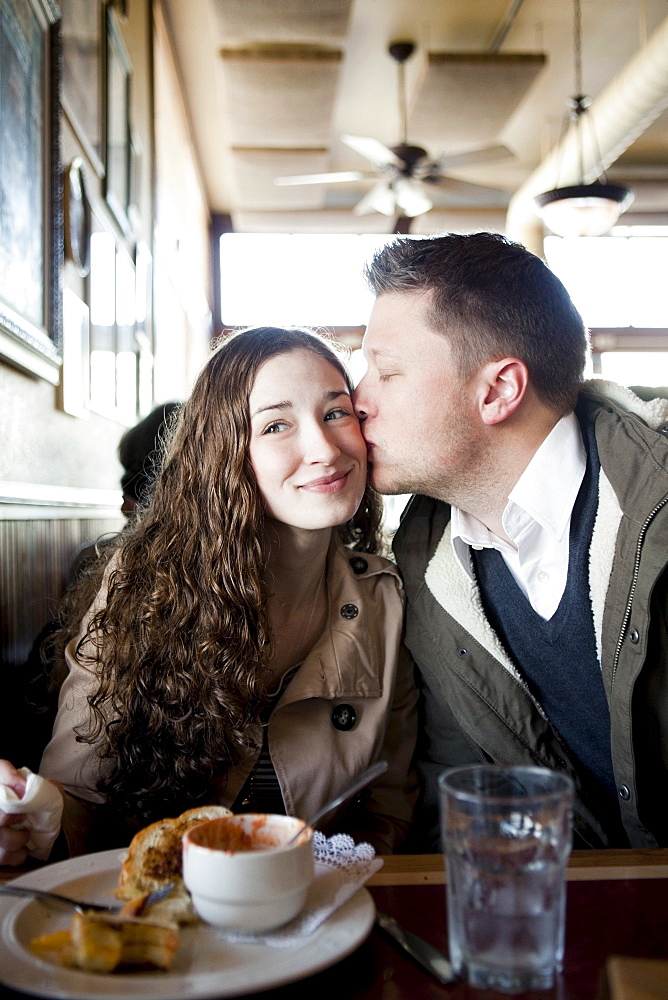 Couple kissing in restaurant