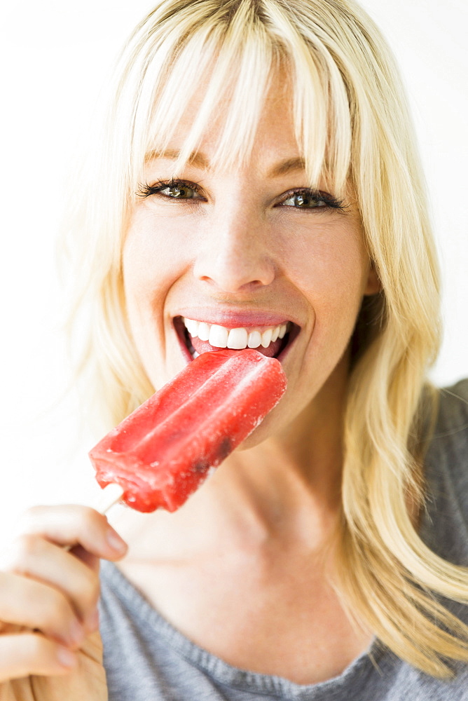 Woman eating ice popsicle