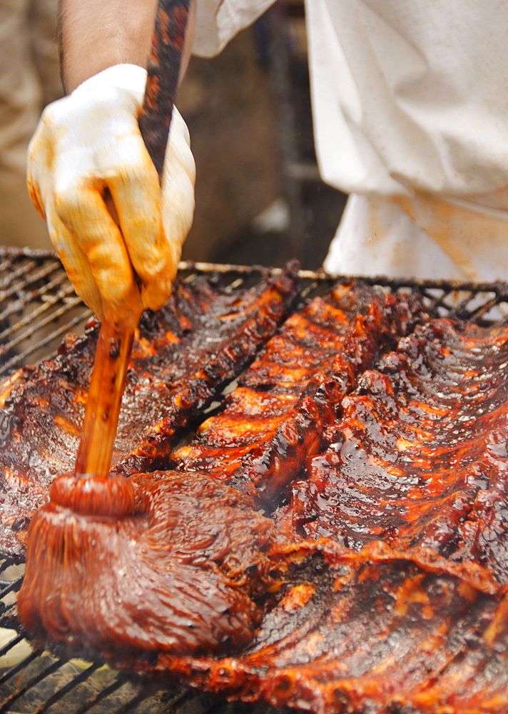 Chef cooking spareribs on barbeque