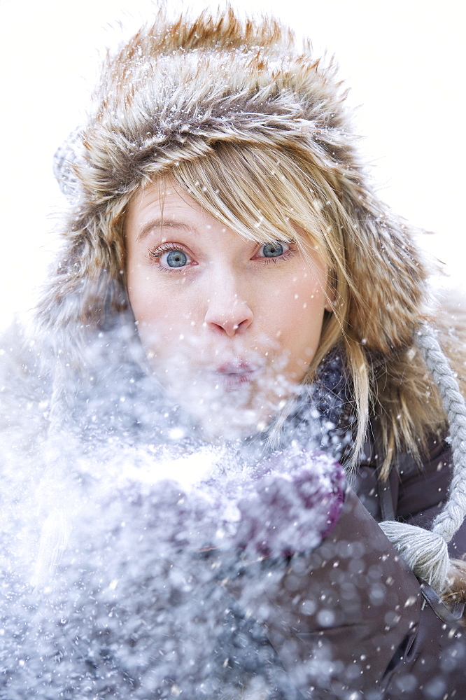 Woman blowing snow