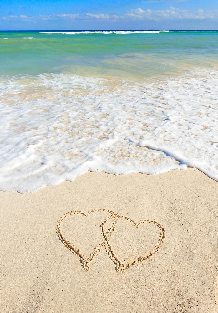 Heart drawing in sand on beach