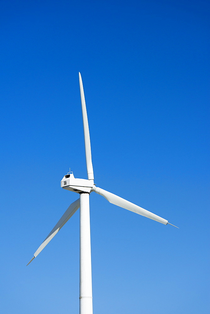 Wind turbine against blue sky