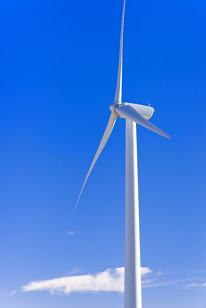 Wind turbine against blue sky