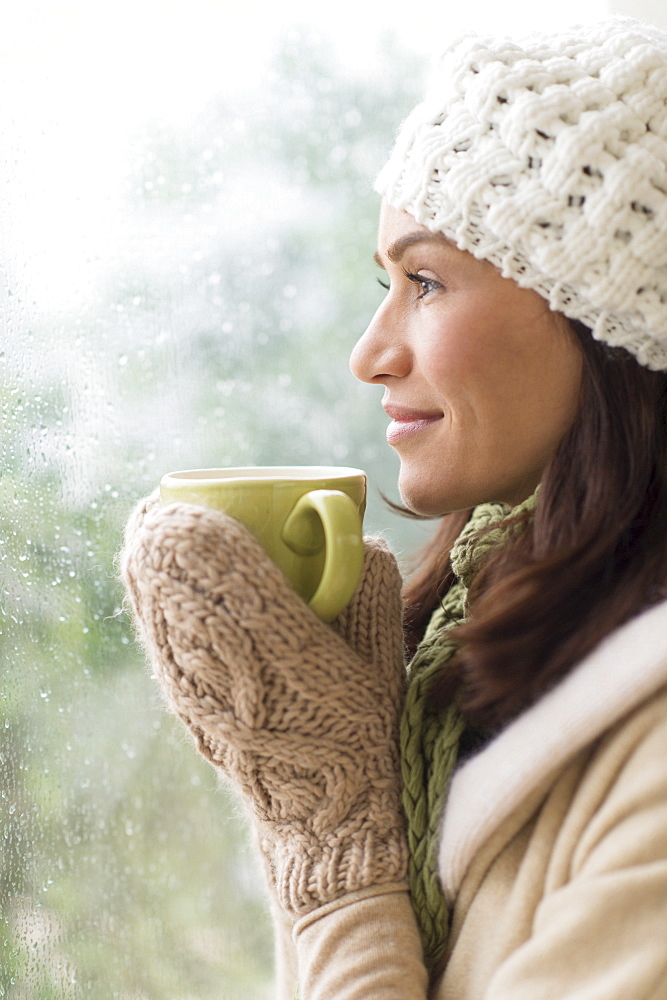 Woman in warm clothes holding mug