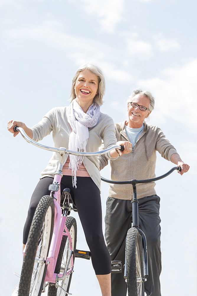 Senior couple riding bicycle