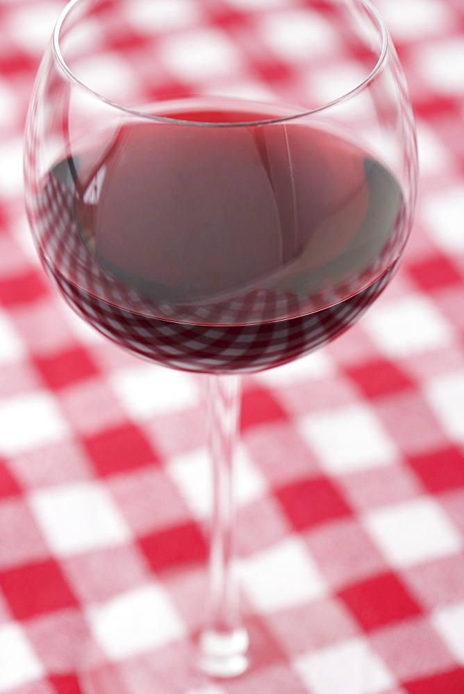 Glass of wine on checkered tablecloth