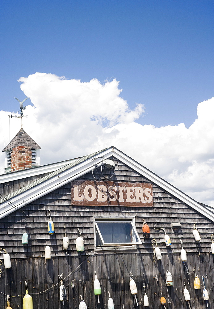 Buoys hanging on shingled building, Maine, United States