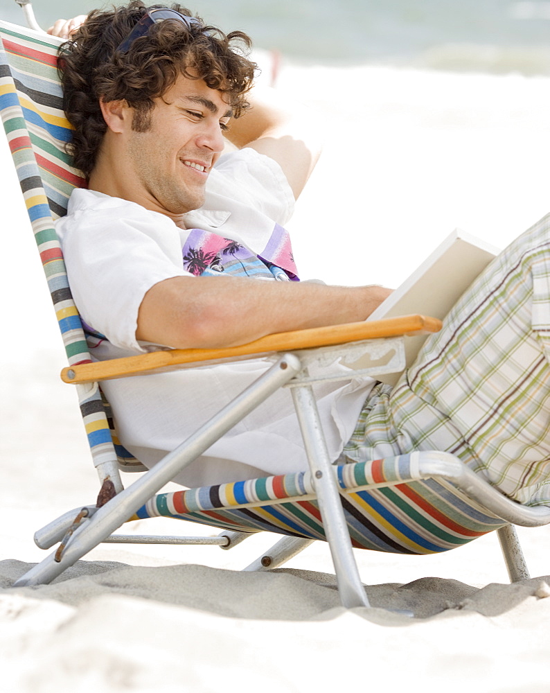 Man reading at beach