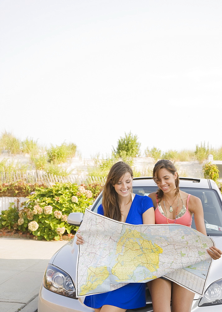 Young women looking at map