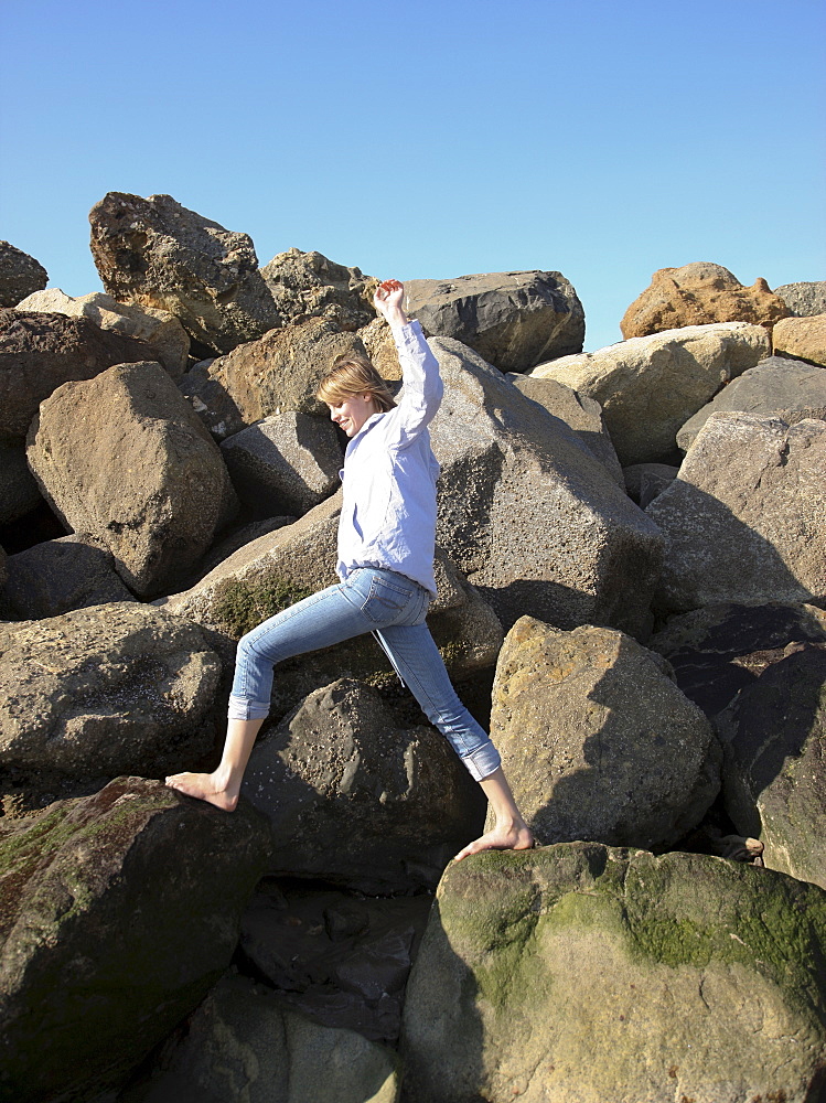 Woman climbing on rocks