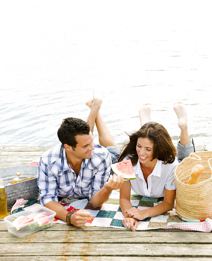 Couple picnicking on dock