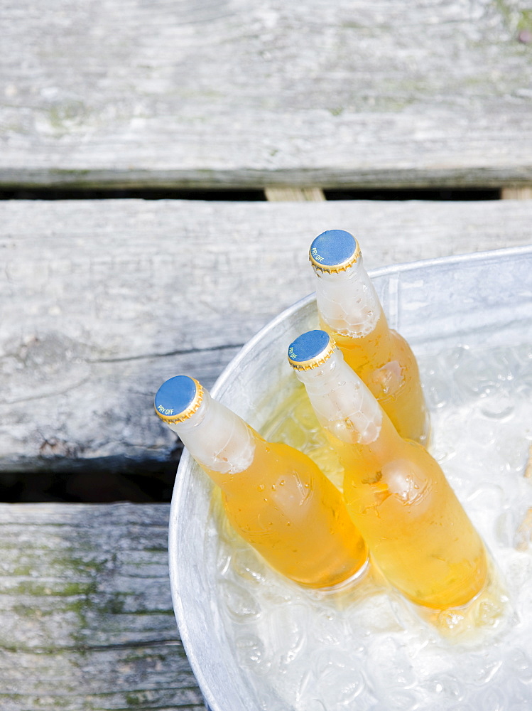 Beer bottles in bucket of ice