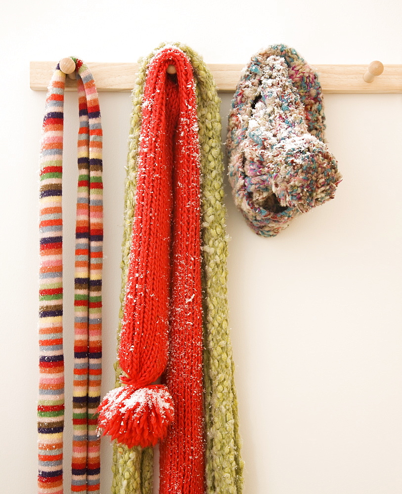 Snowy scarves hanging on rack