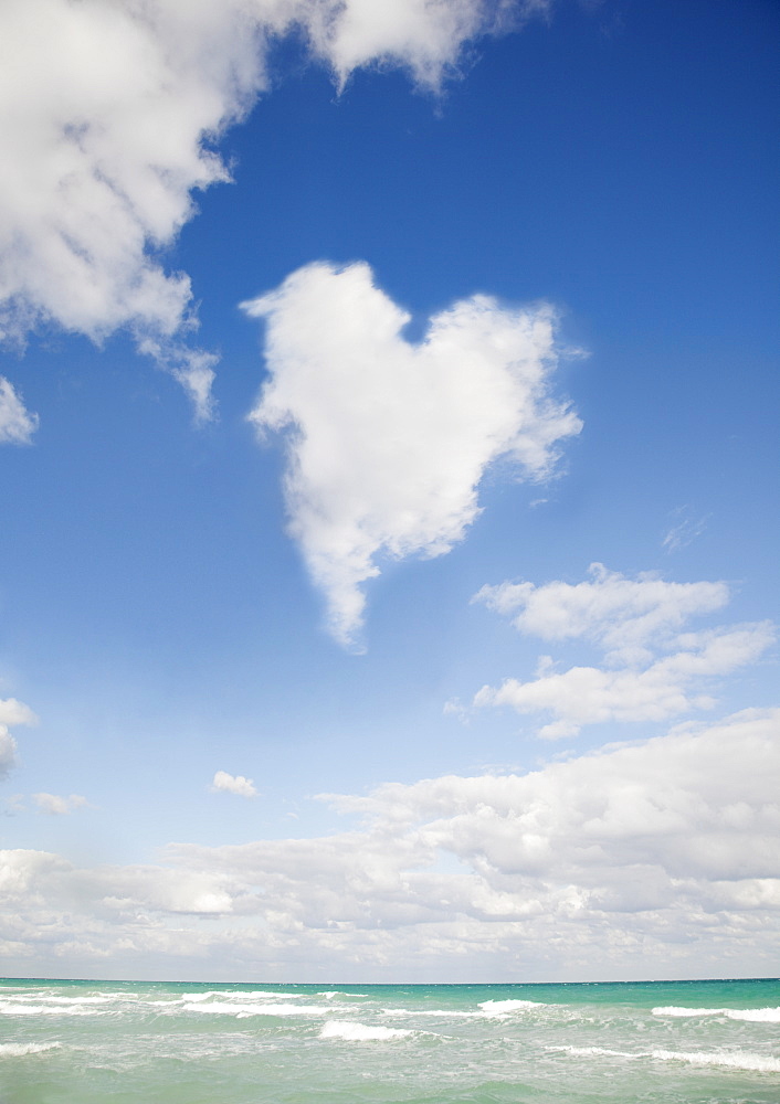 Heart shaped cloud over ocean