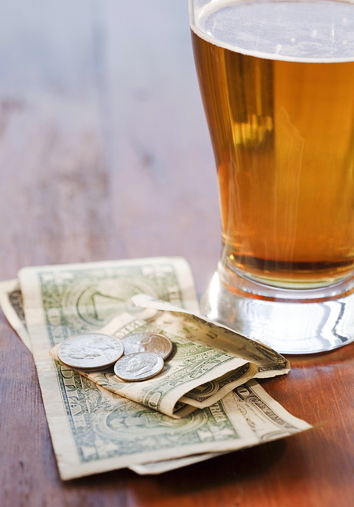 Close up of beer and money