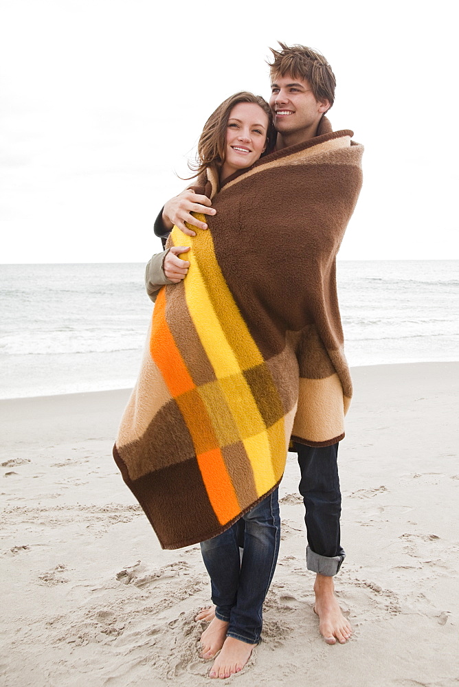 Couple wrapped in blanket