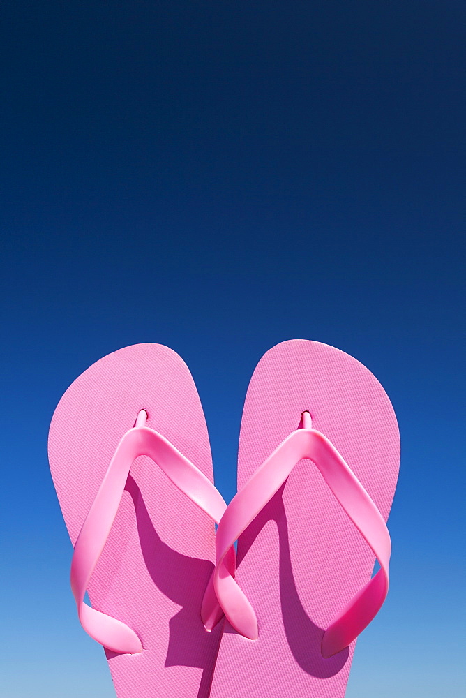 Oregon, Florence, Pink flip-flops against blue sky