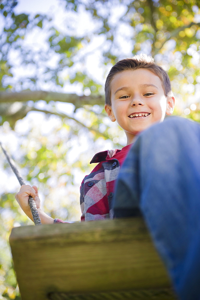 USA, New York, Flanders, Boy (8-9) playing in garden