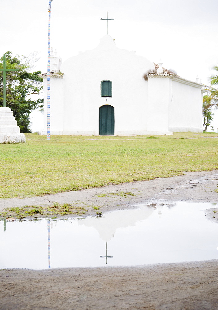 Brazil, Bahia, Trancoso, Church reflecting in puddle