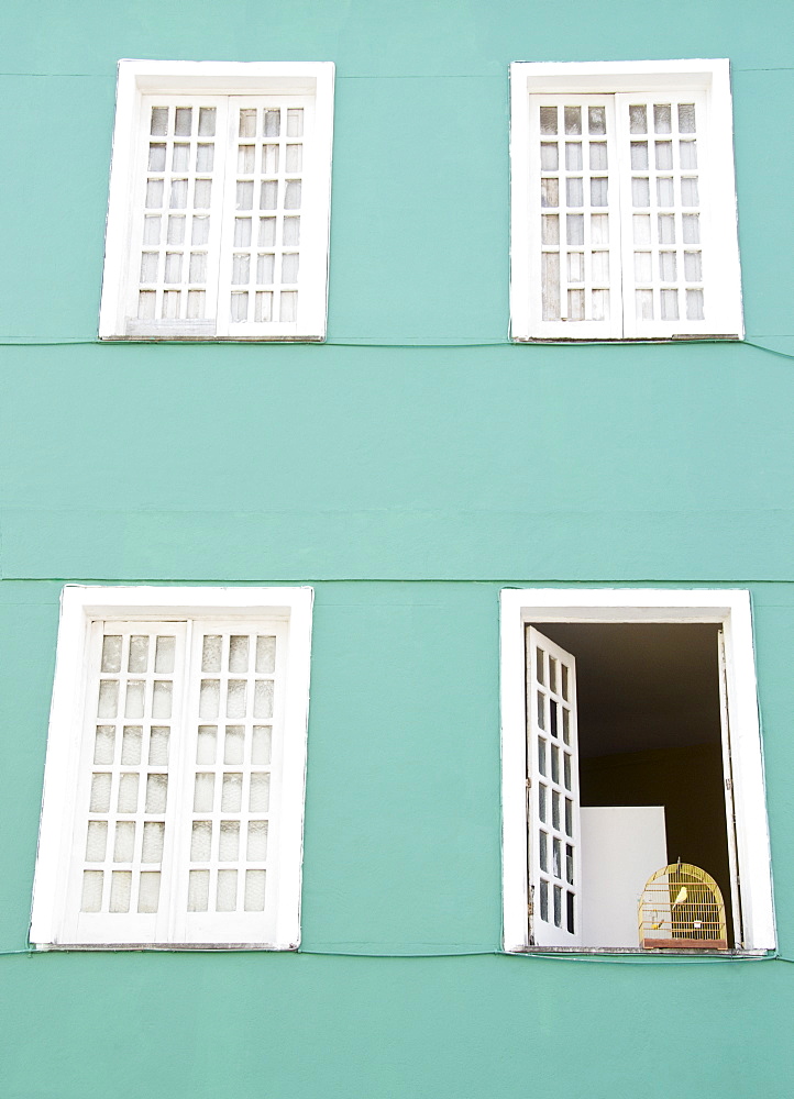 Brazil, Bahia, Salvador De Bahia, Facade of building with birdcage on open window