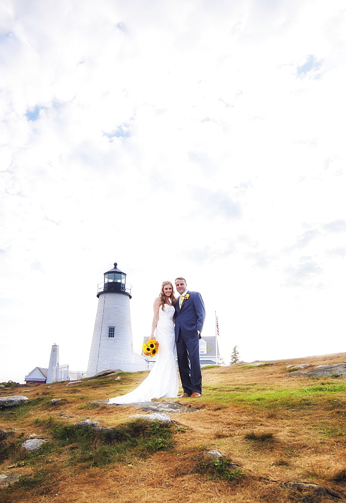 Portrait of married couple, lighthouse in background, USA, Maine, Bristol 