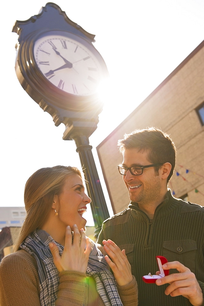 Man proposing to woman on street