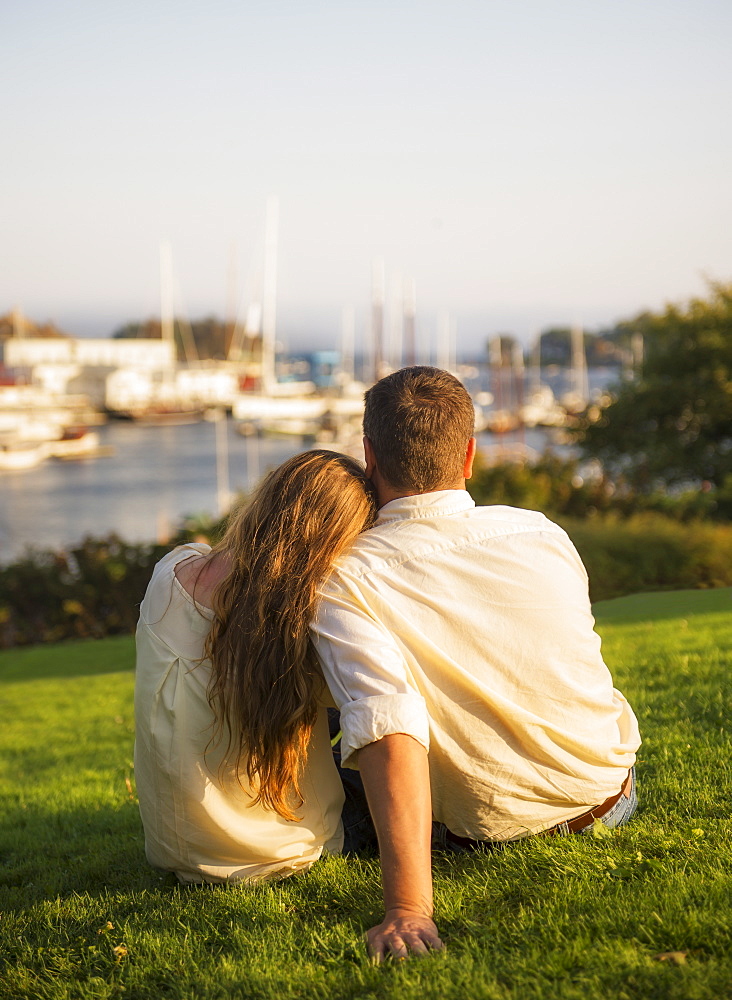 Back view of couple looking at harbor, Camden, Maine