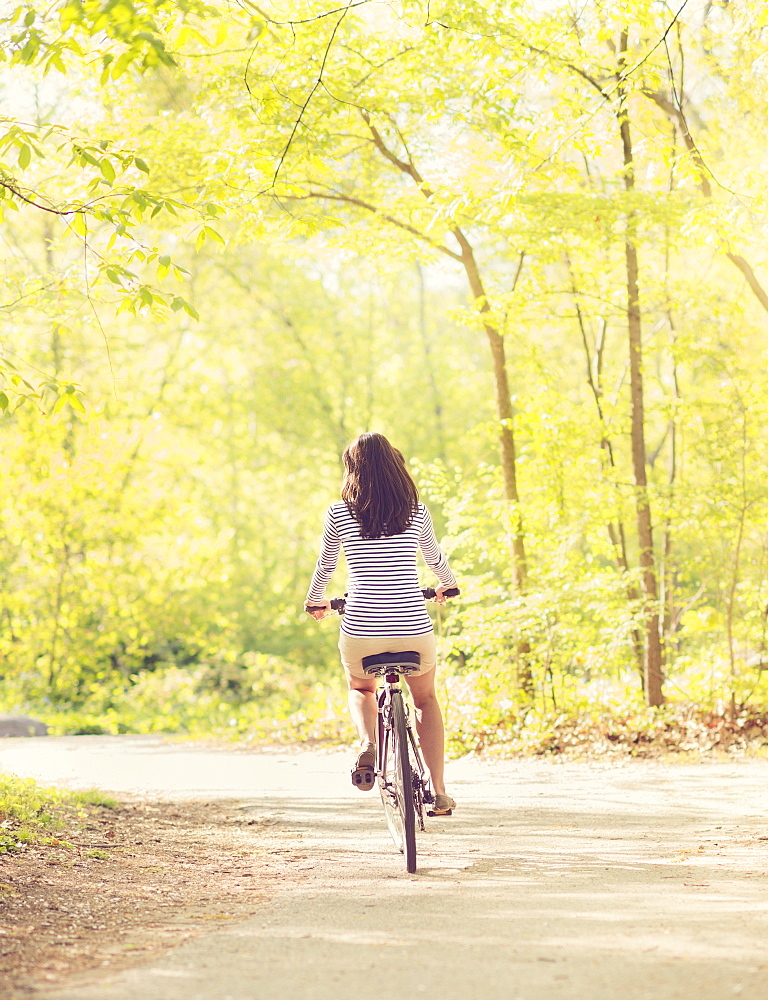 Mid adult woman riding bicycle, Central Park, New York City