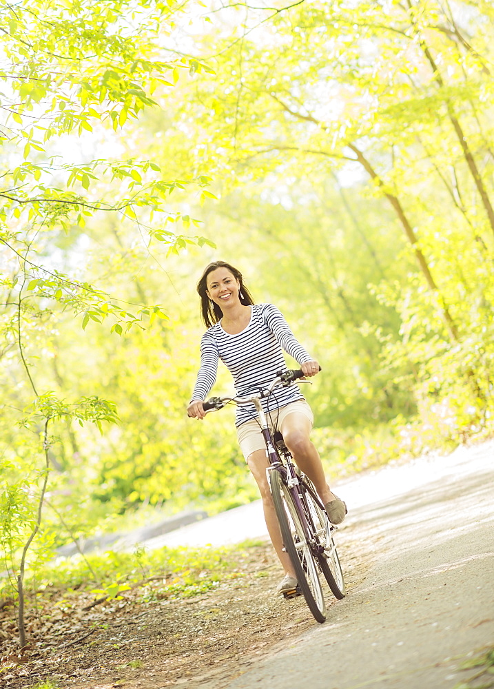 Mid adult woman riding bicycle, Central Park, New York City