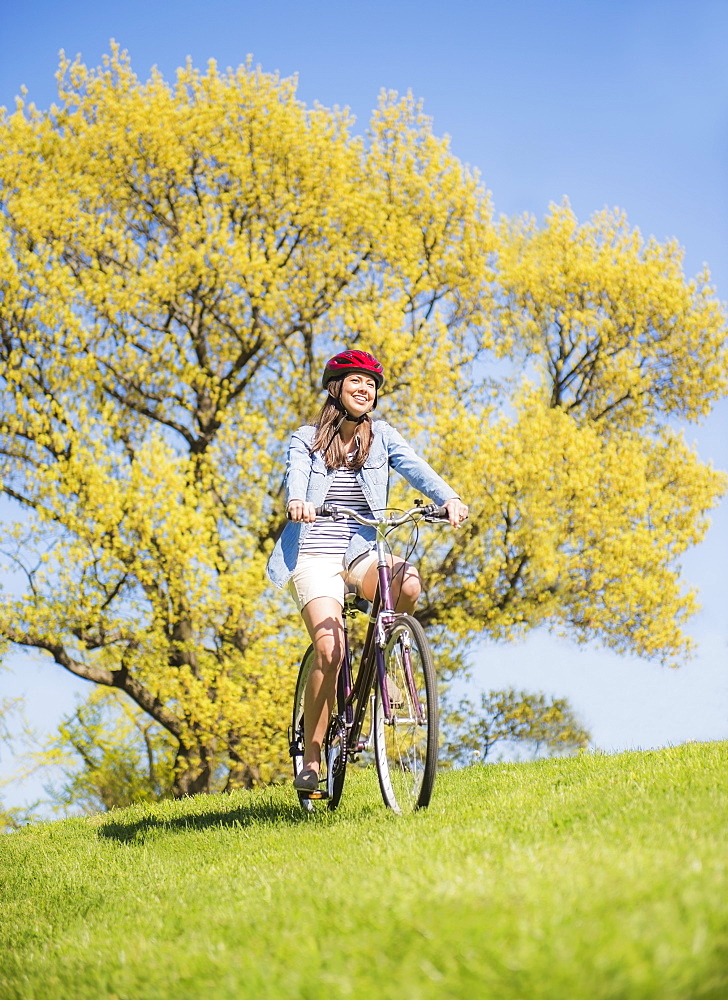 Mid adult woman riding bicycle, Central Park, New York City