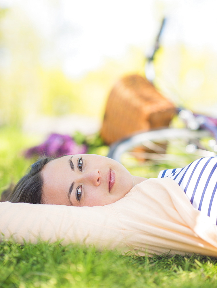 Portrait of mid adult woman relaxing in park, Central Park, New York City