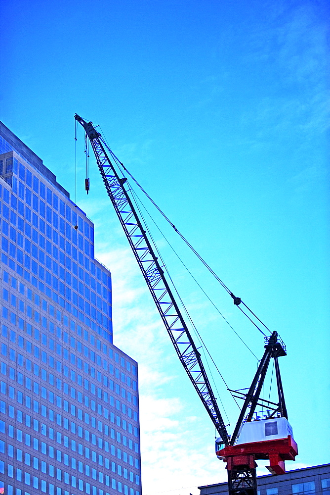 Crane and high-rise under blue sky