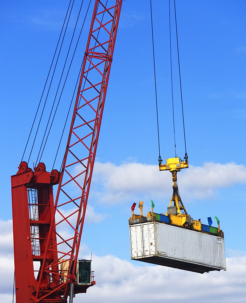 Crane lifting a shipping container