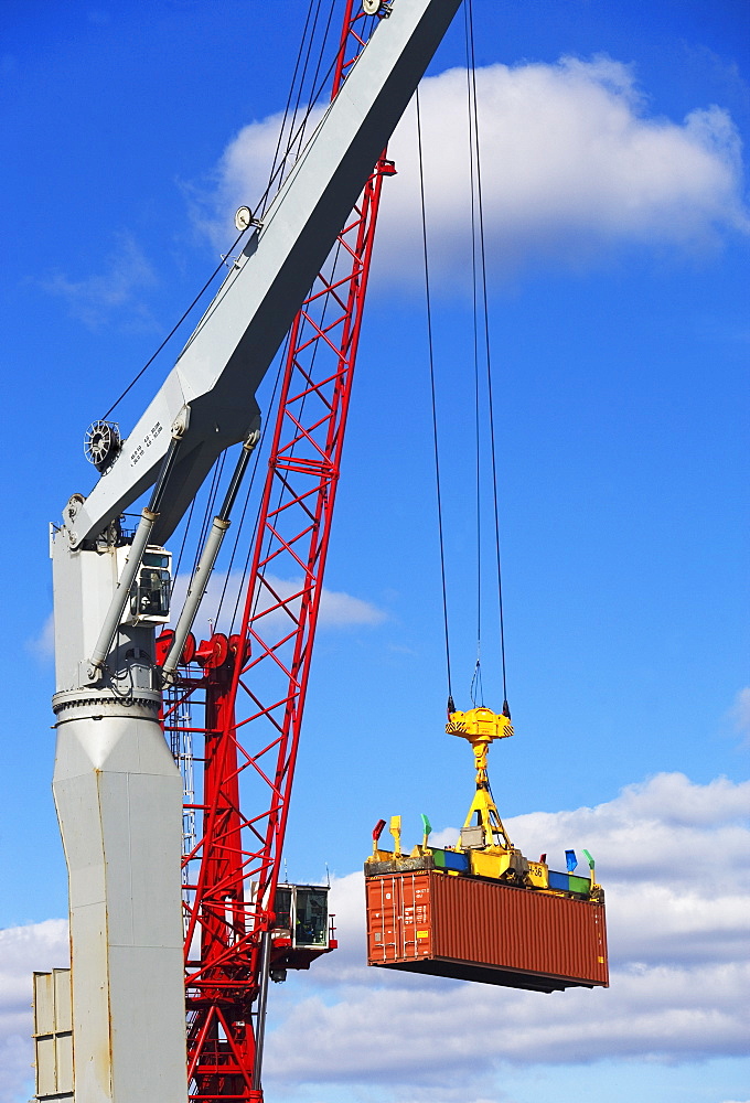 Crane lifting shipping container