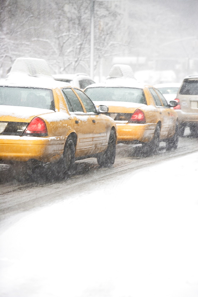 USA, New York City, yellow cabs on snowy street