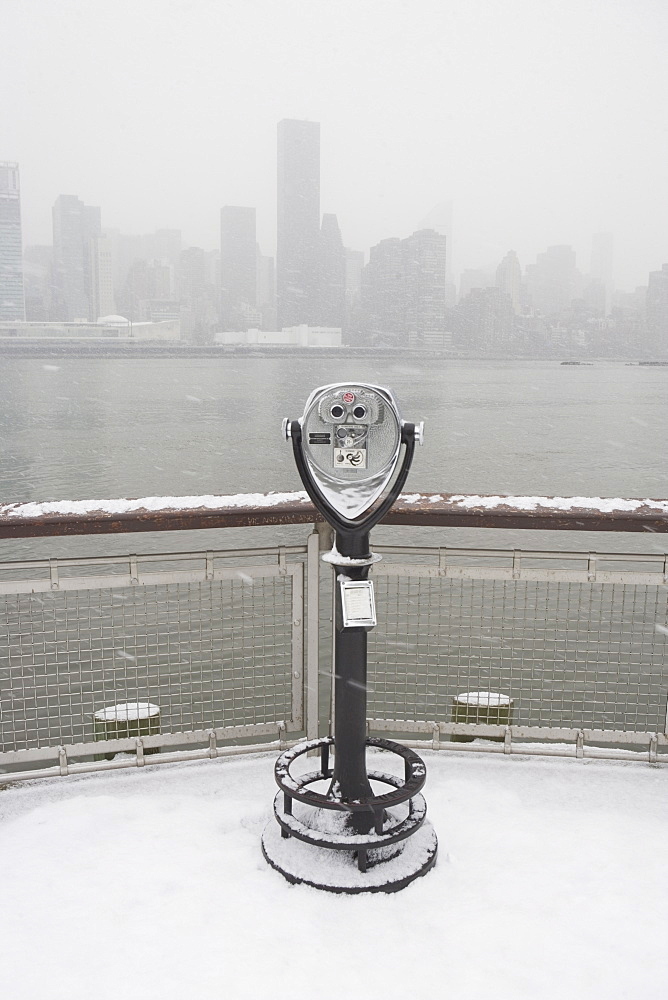 USA, New York City, coin operated binoculars overlooking foggy Manhattan