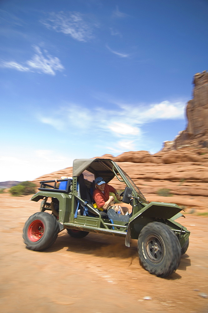 Man driving off-road vehicle in desert