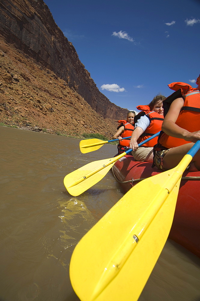 People paddling in raft