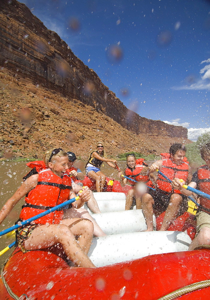 People paddling in raft