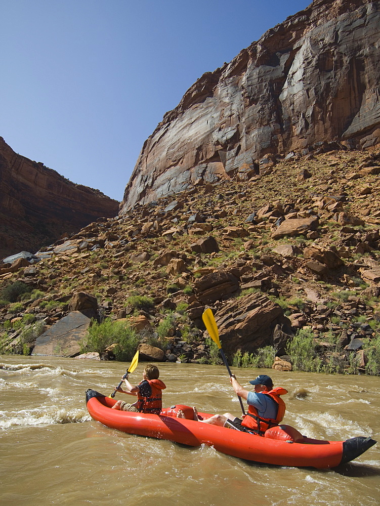 People paddling in raft