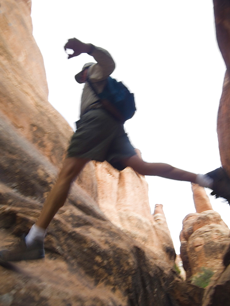 Man jumping over rock formations