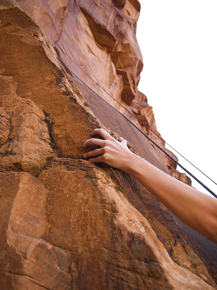 Close up of womanâ€™s arm rock climbing