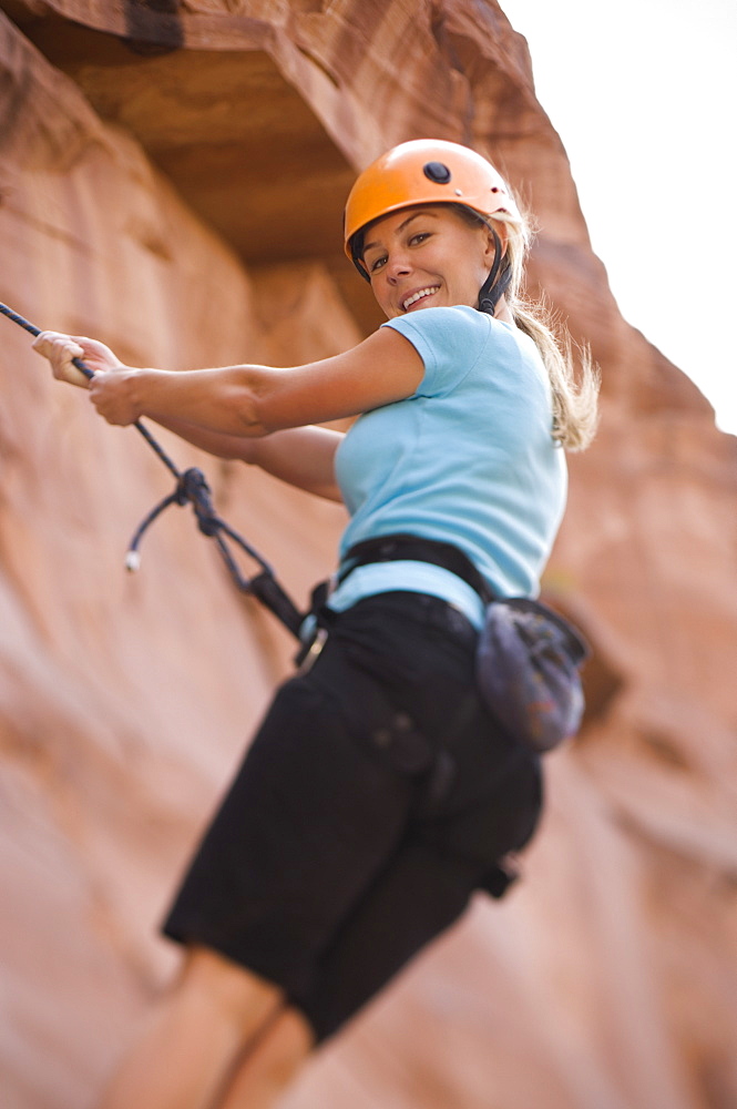 Close up of woman rock climbing