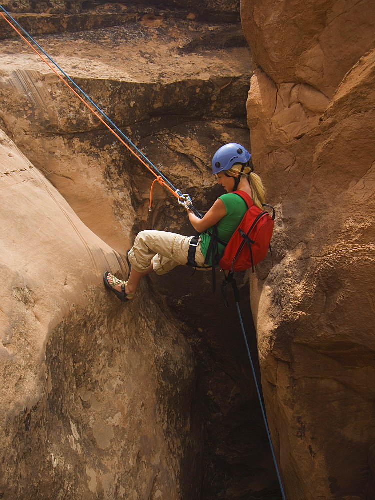 Woman canyon rappelling