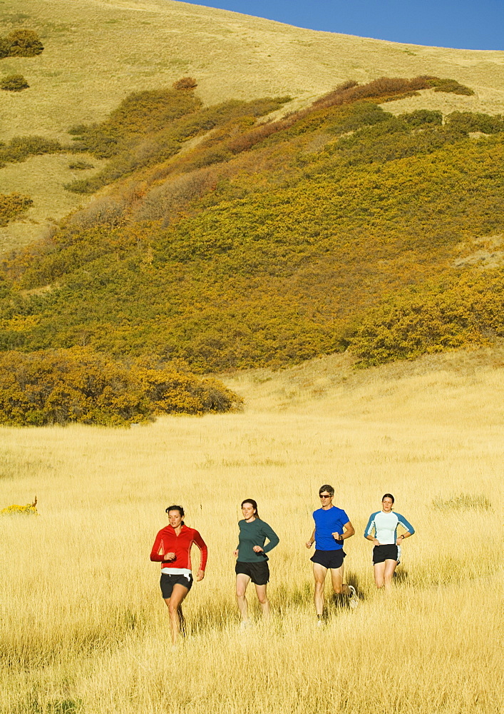 Group of people running in field, Salt Flats, Utah, United States