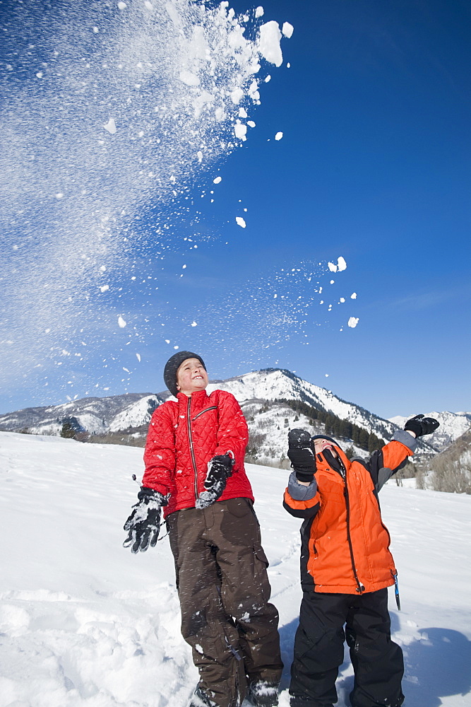 Brothers playing in snow