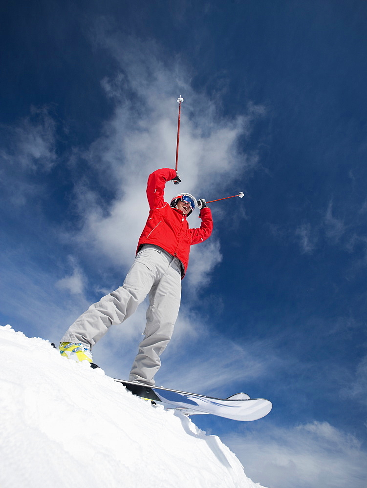 Man on skis with arms raised