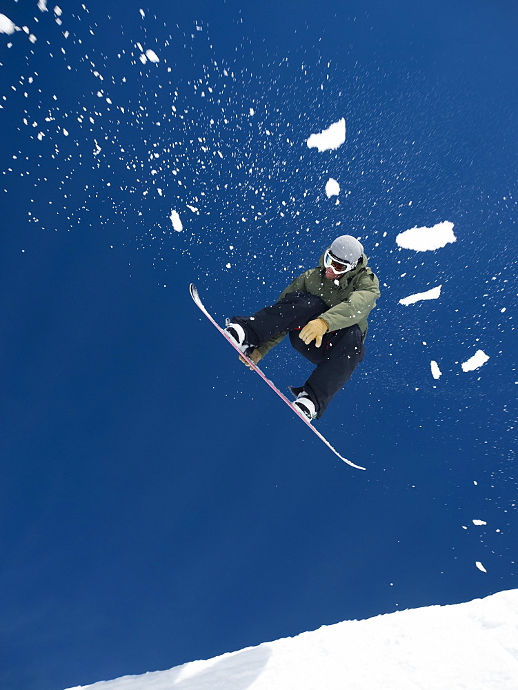 Man on snowboard in air