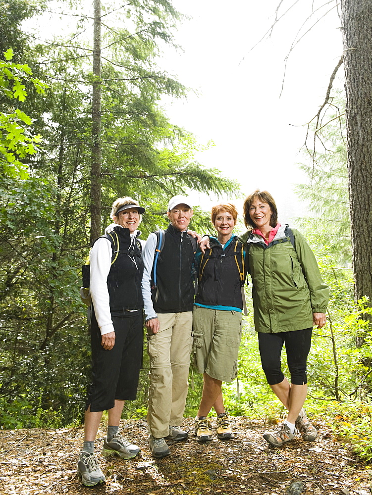 Female hikers posing in forest