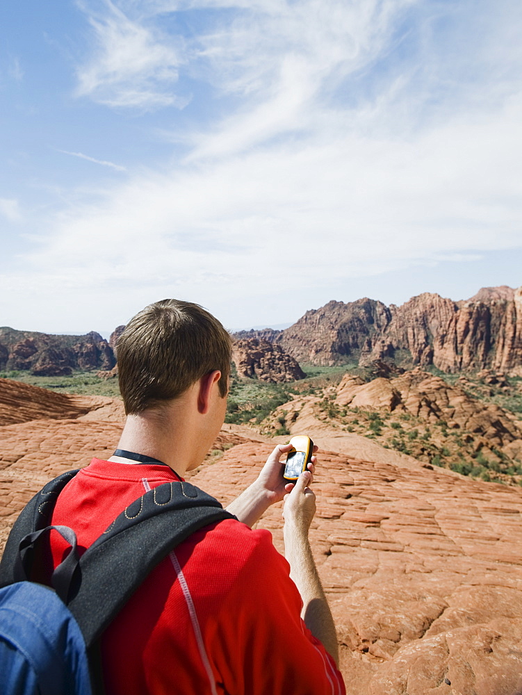 A man at Red Rock holding a GPS